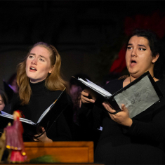 Kai Cleary and Jordan Calderon sing with the Kirkpatrick Choir during the concert.
